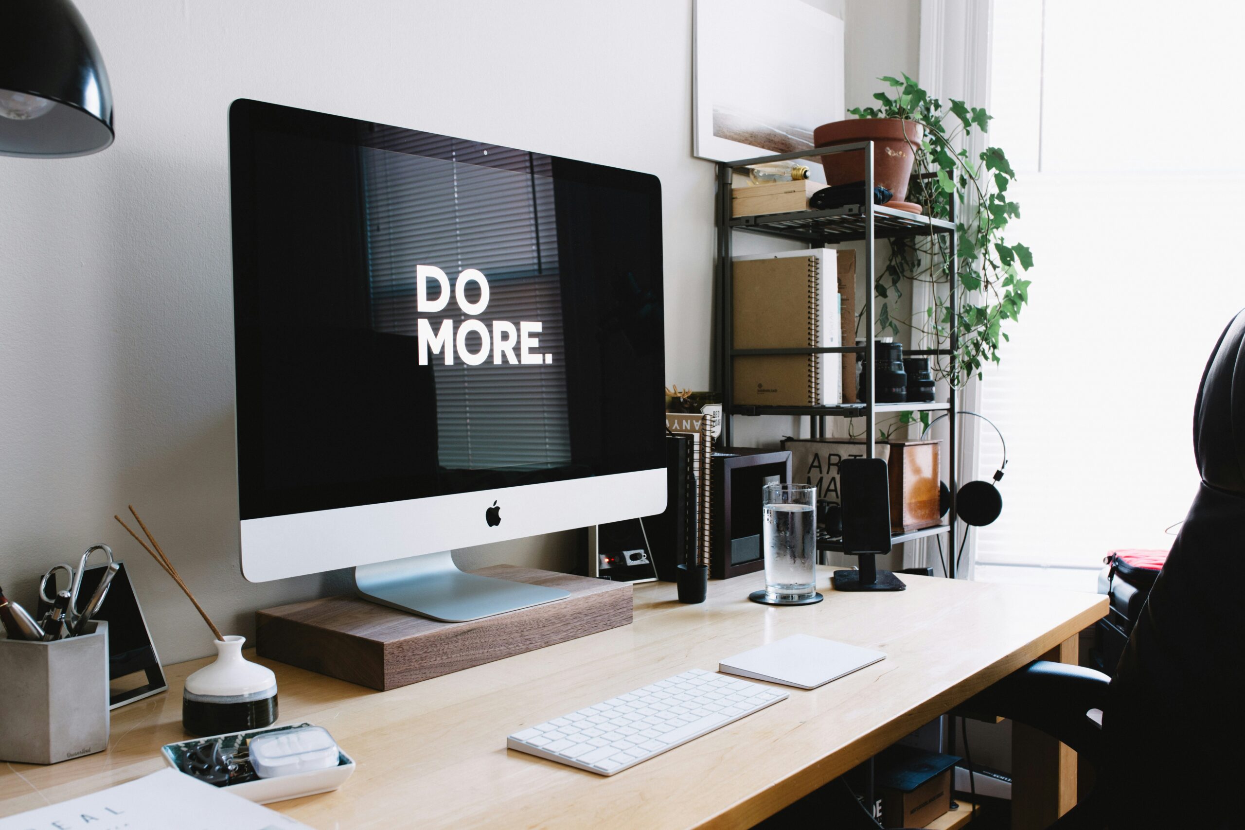 Image of a computer screen displaying the words 'Do more' against an organized workspace backdrop, symbolizing effective time management and productivity.