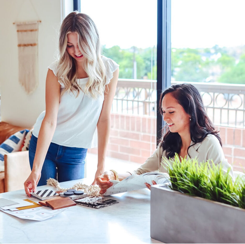A picture of two Thrive Coworking for Women members working together at a community table.