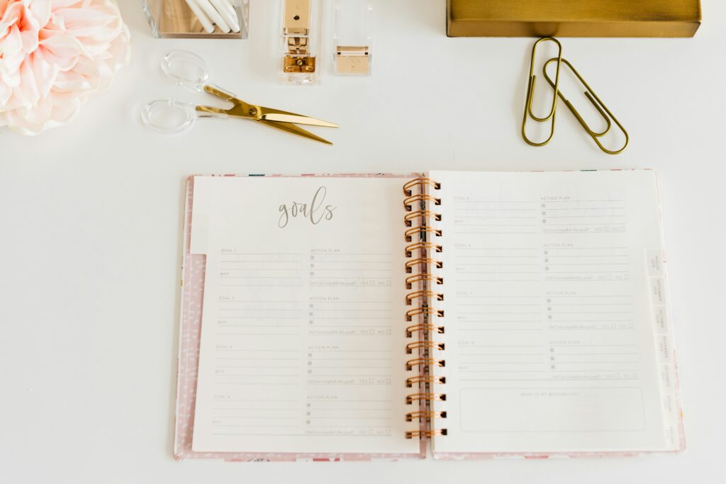 Image of a goal planner sitting on a desk, symbolizing routines and quarterly planning.
