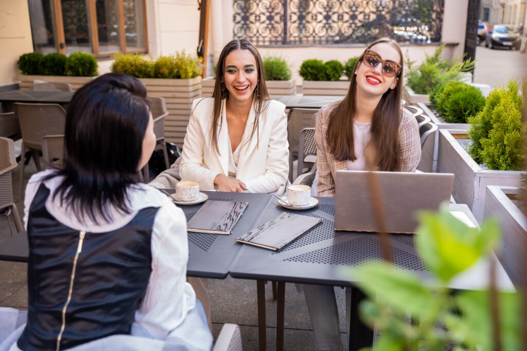 Women sitting together over coffee and working.