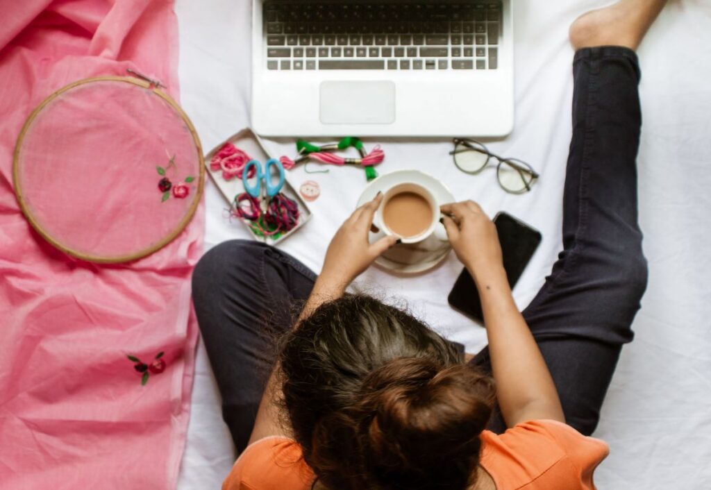Image of woman sitting in front of her laptop with hobby.